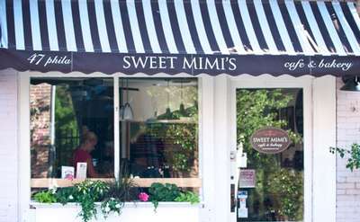 exterior of sweet mimis featuring a navy and white striped awning