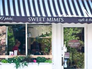 exterior of sweet mimis featuring a navy and white striped awning