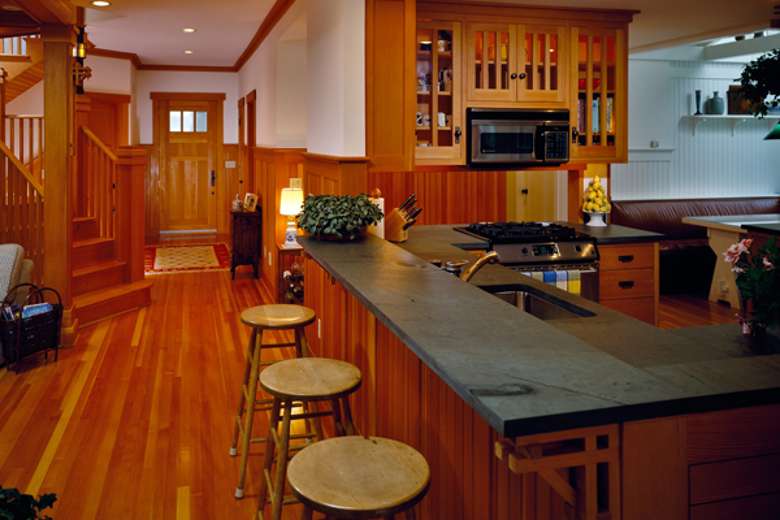 kitchen area with wooden floors, a breakfast bar, and stools