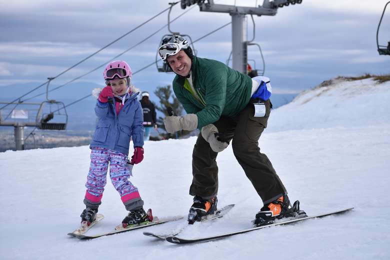 man and girl on skis