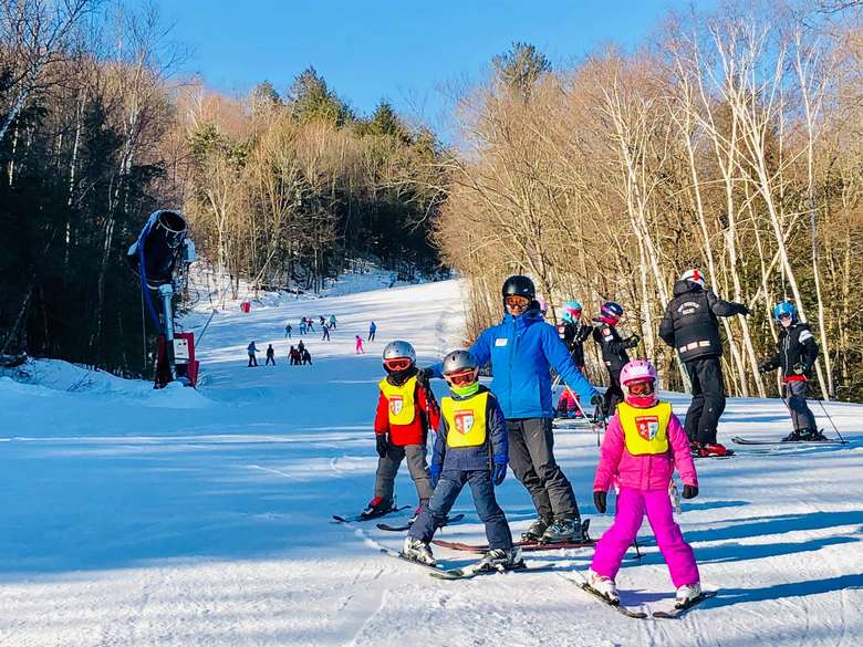 adult and kids on skis