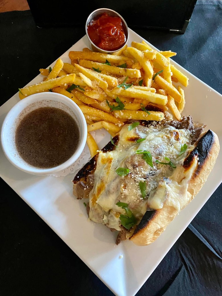 view of a sub sandwich and fries