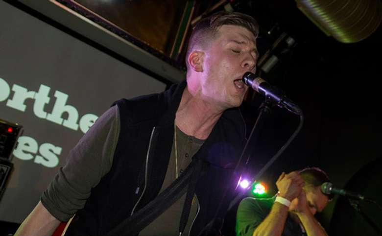 lead singer of a band performing in a bar