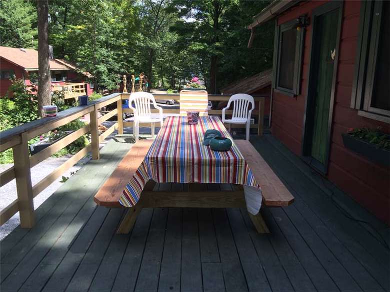 picnic table with striped tablecloth on deck