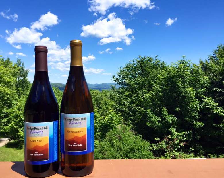 two bottles of wine with a scenic backdrop