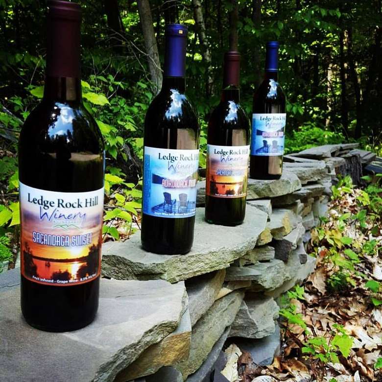 bottles of wine lined up on stone pillars