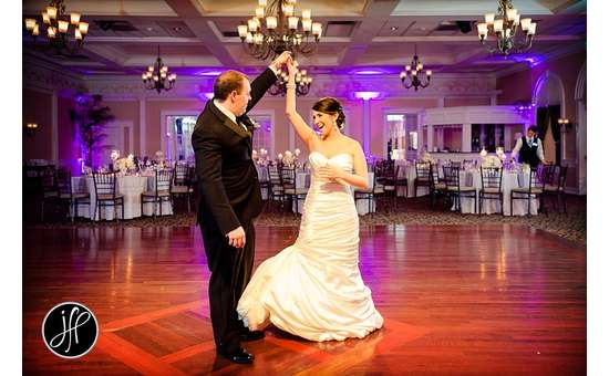 groom twirling bride on the dance floor