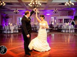 groom twirling bride on the dance floor