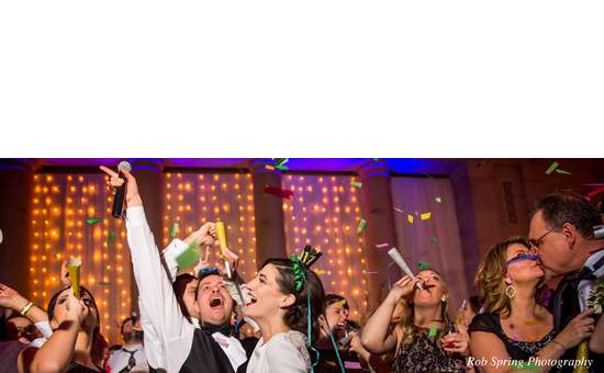 bride, groom, and guests dancing