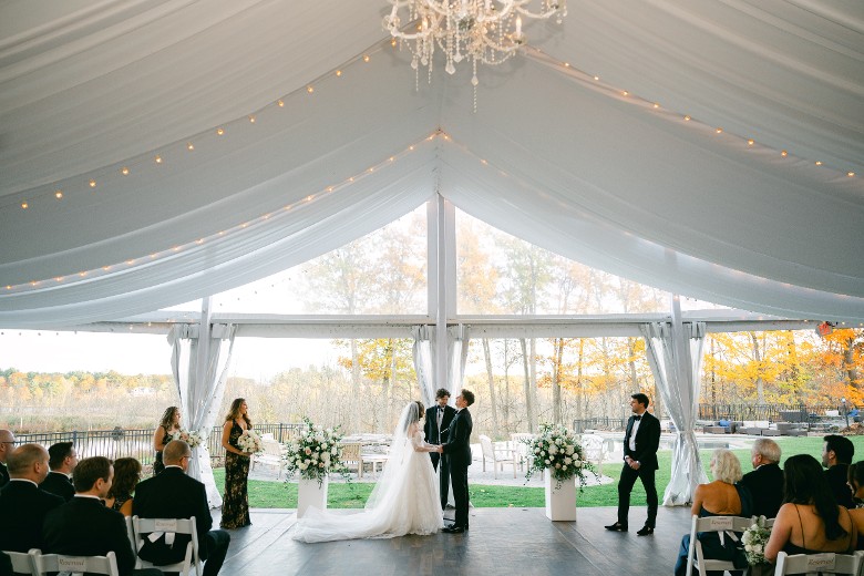a wedding ceremony inside the tent at Saratoga National