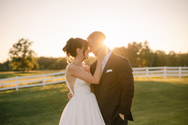 a bride and groom on the golf course at sunset