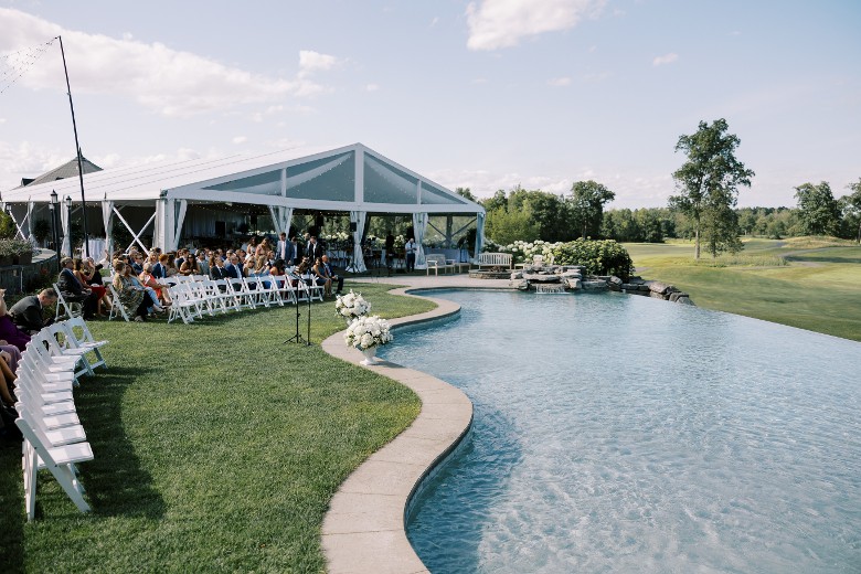 an outdoor ceremony setup by the infinity pool