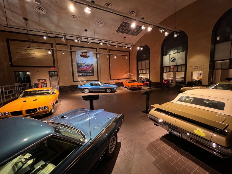cars on display inside of a museum