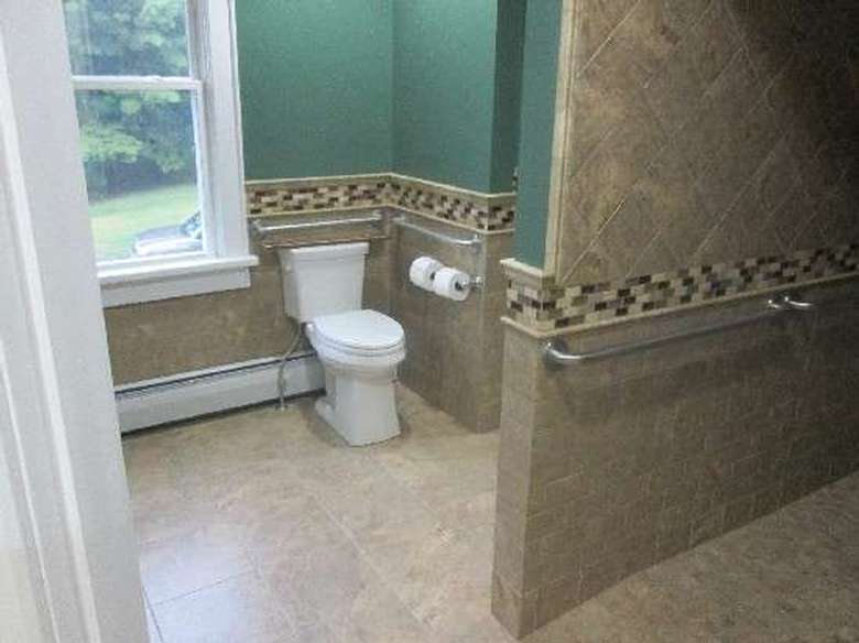 bathroom with tiled walls