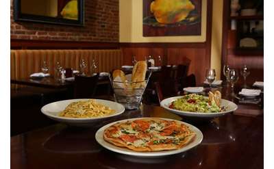 pasta, pizza, salad, bread on table