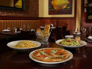 pasta, pizza, salad, bread on table