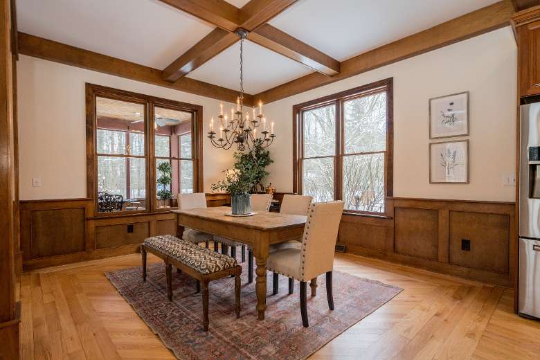 dining room table off of the kitchen with large windows