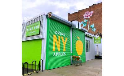 Nine Pin Cider's front garage doors that read 