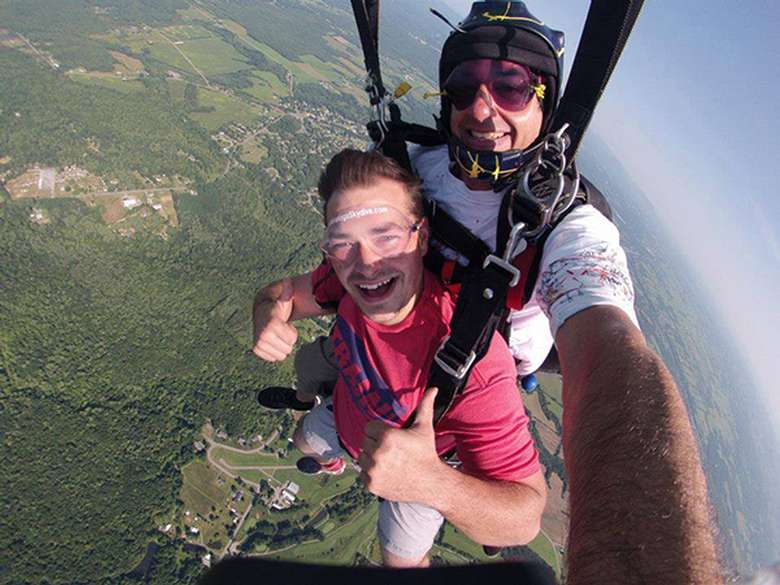 Man doing a tandem jump with a guide
