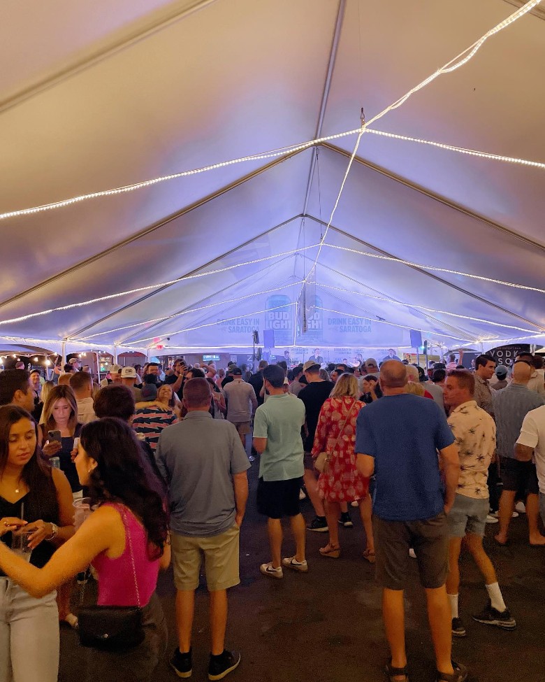 people in tent at horseshoe