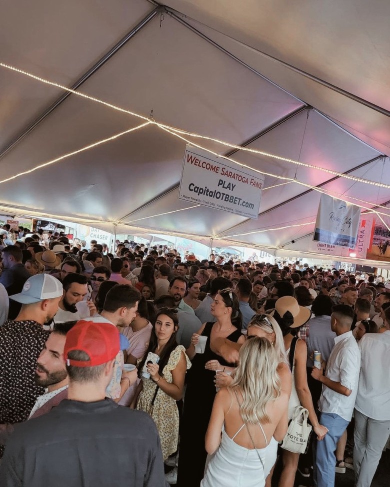 people in tent at horseshoe