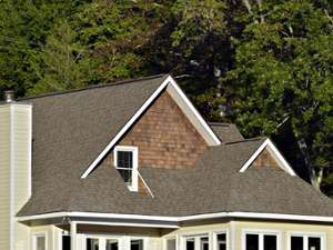 a multi-floor house with a large roof