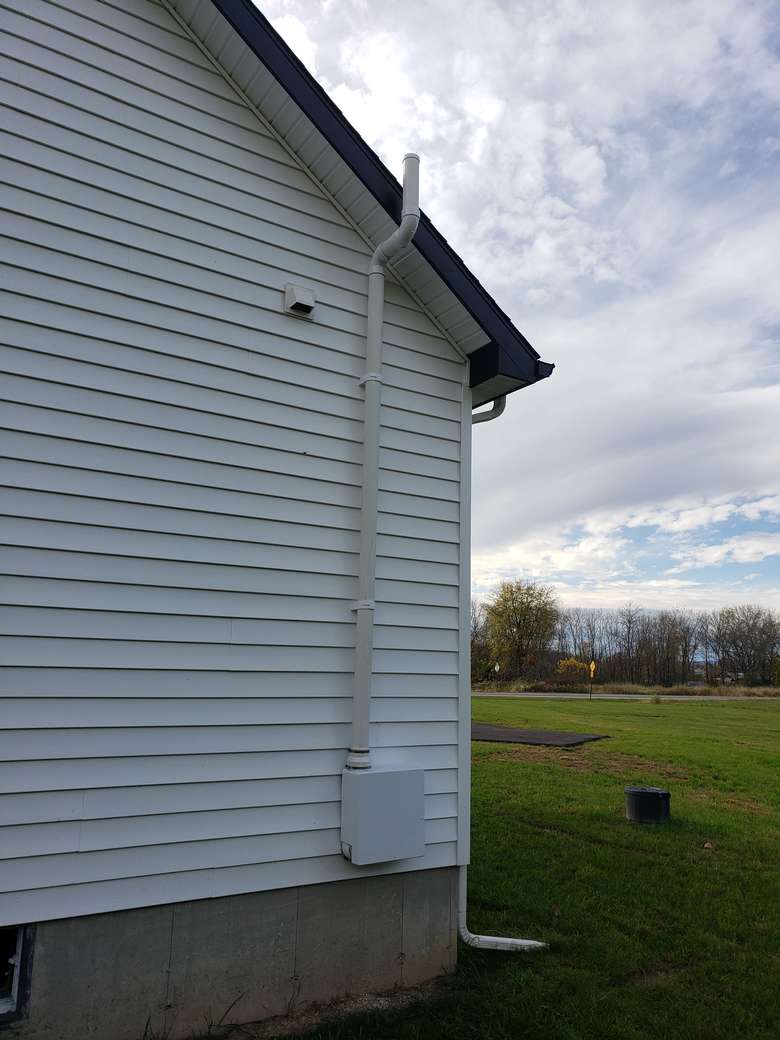 side of house with pipe