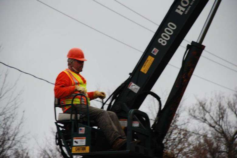 man operating a tree removal crane