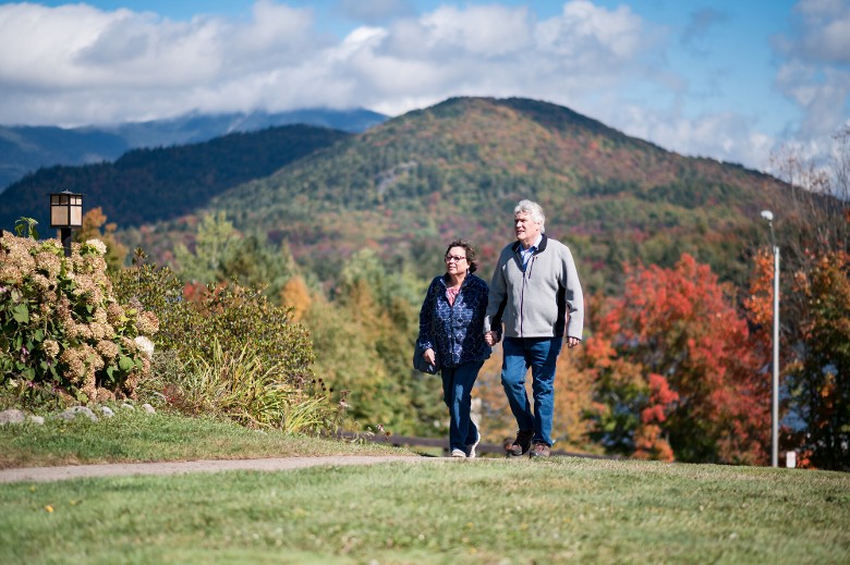 couple walks with mountains in background