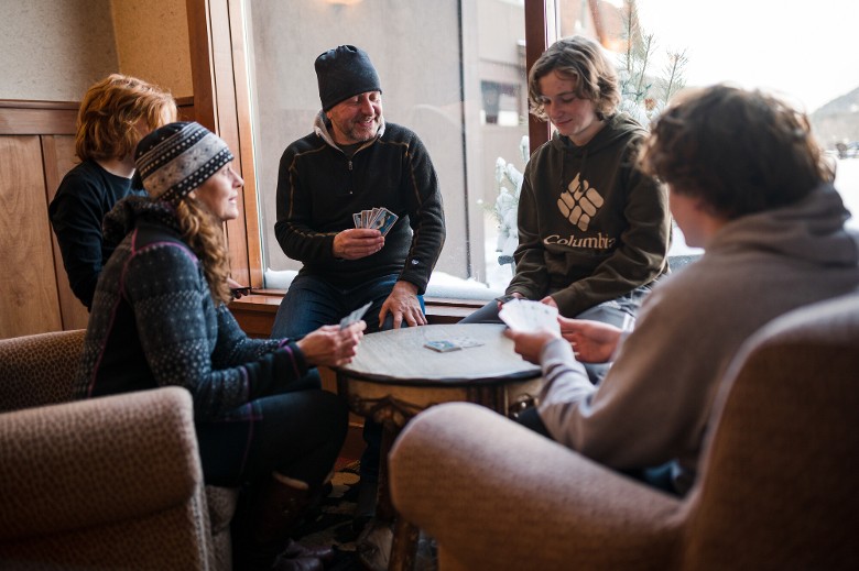 group of young people play cards