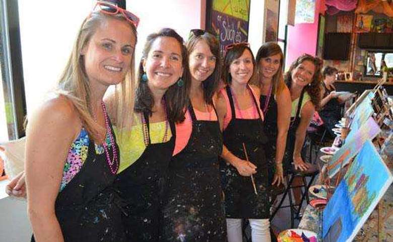 group of women posing after a paint and sip
