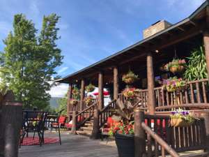 a sunny day at a rustic restaurant with a wooden patio