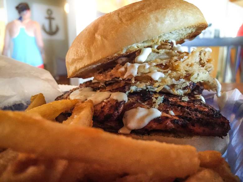 a burger with crispy fried onions