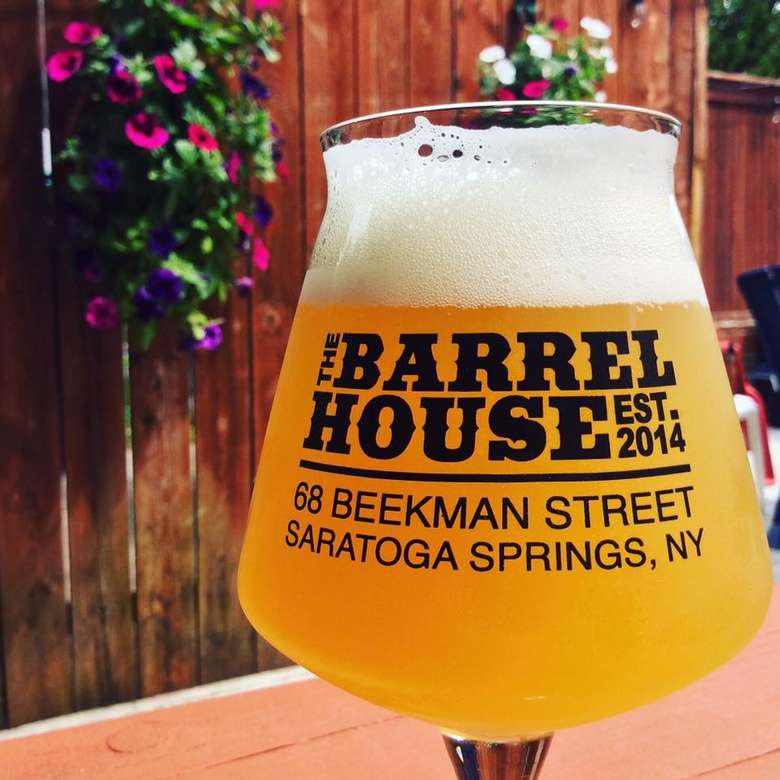 a glass of beer outside with the Barrelhouse logo