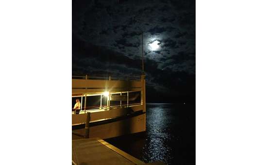 bow of a steamboat with the moon in the background