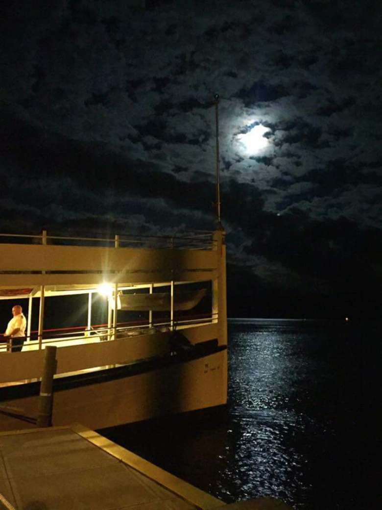 bow of a steamboat with the moon in the background