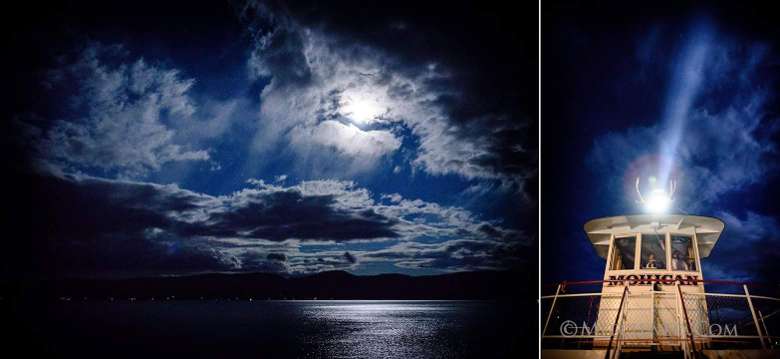 moon partially obscured by clouds over lake george and the captain's cabin on the mohican