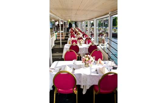 tables on a boat set up for a wedding reception