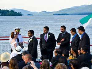 boat captain marrying a bride and groom as the guests look on