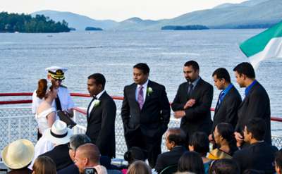 boat captain marrying a bride and groom as the guests look on