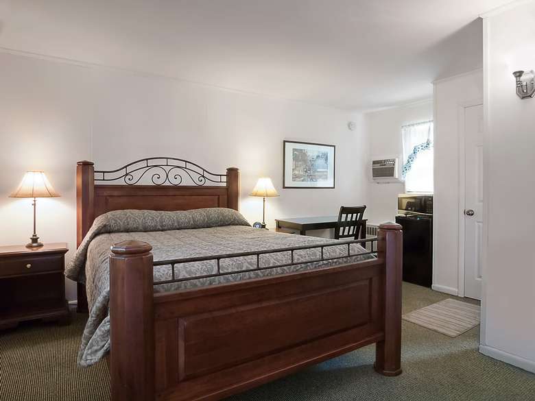 motel room with a king size bed and a desk