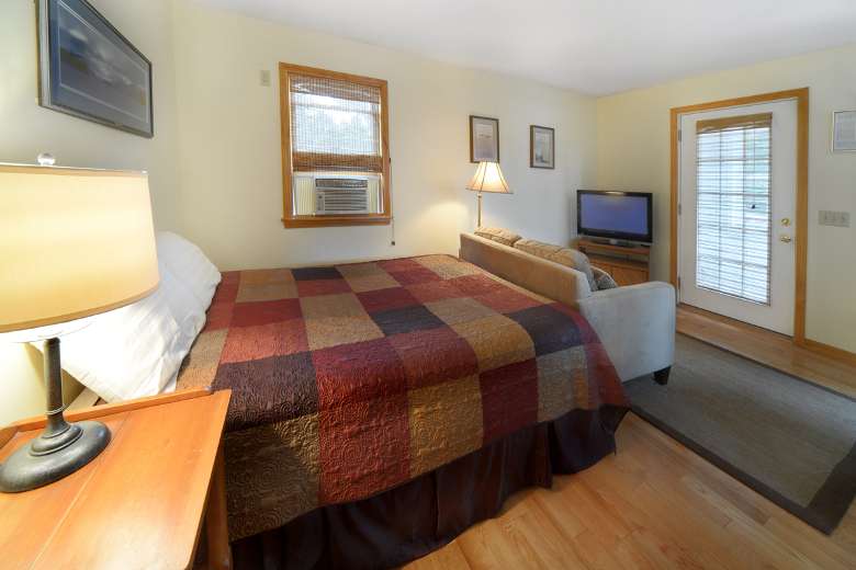 motel room with a bed with checkered pattern on blanket