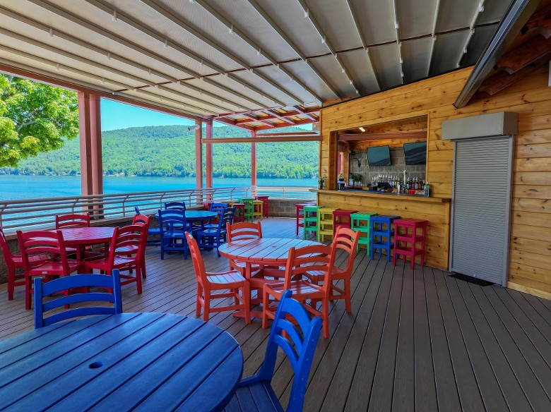 bright chairs on a deck by a bar