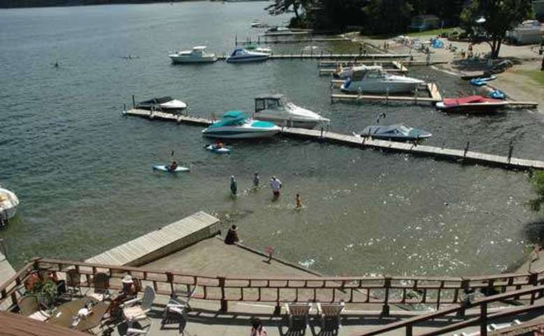 aerial view of a beach, swimming area, and docks on lake george