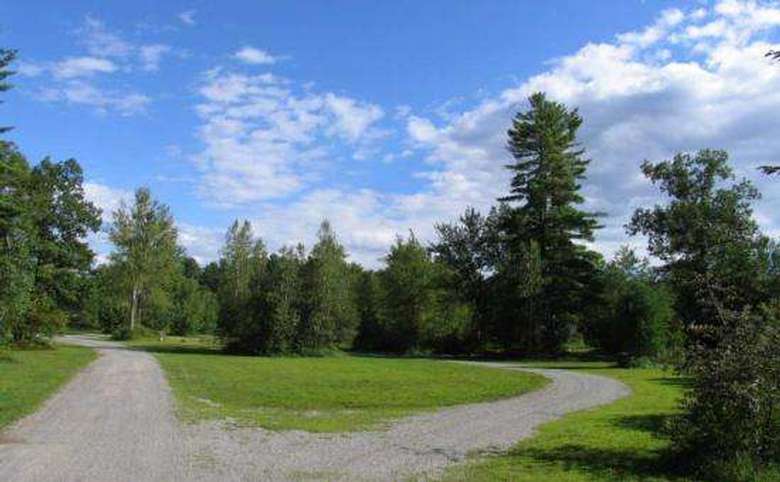 green space with dirt road at lake george escape