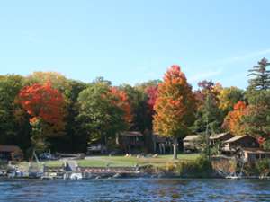 view of cottages from the water, fall foliage on trees