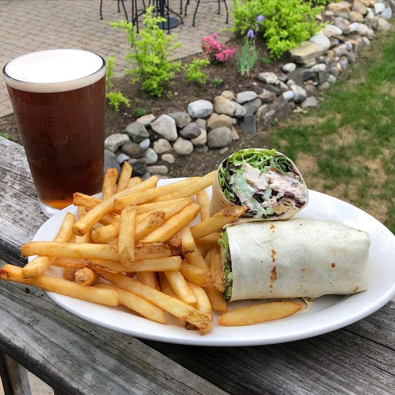 chicken wrap with fries and beer outside