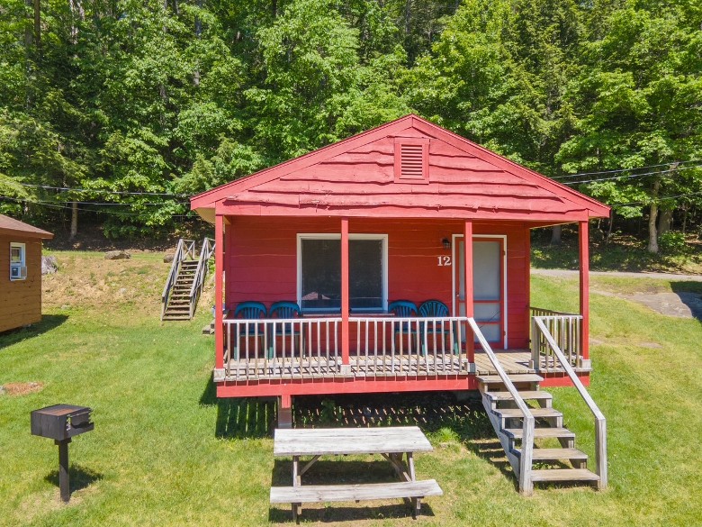 red cottage with deck