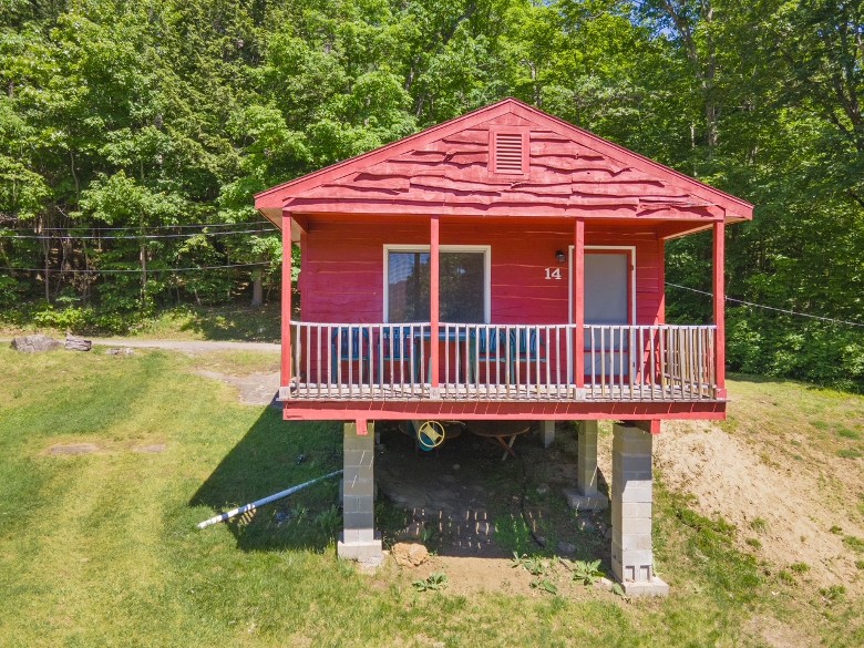 red cottage with deck