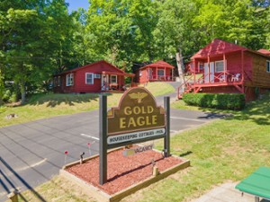 sign for Gold Eagle outside of red cabins